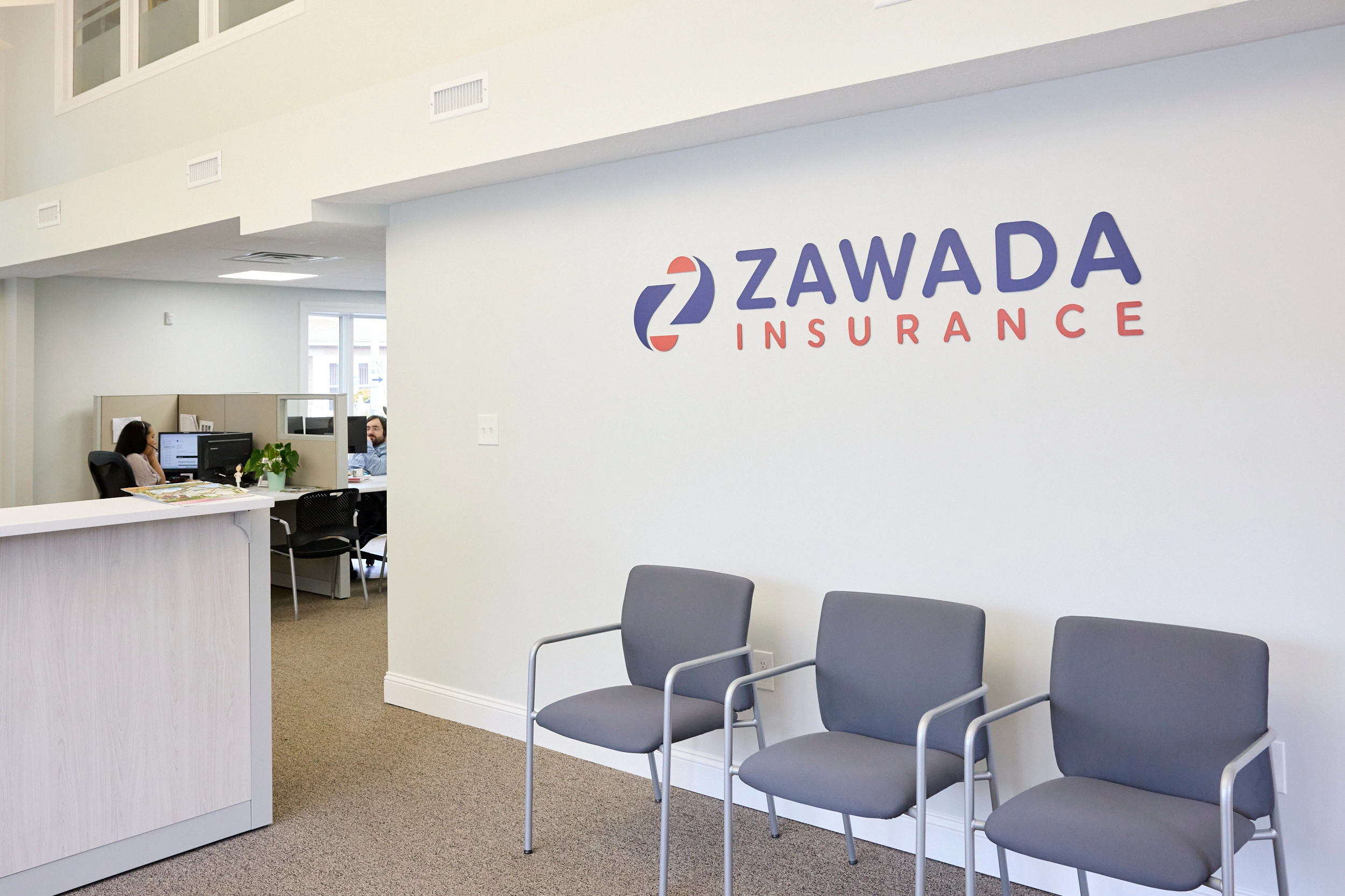 Zawada Insurance lobby with waiting area chairs and branded wall logo